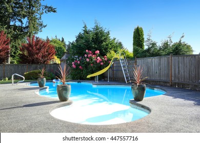 Fenced Backyard With Small Beautiful Swimming Pool And Playground