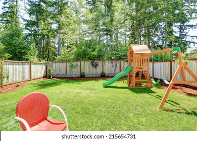 Fenced Backyard With Wooden Playground For Kids