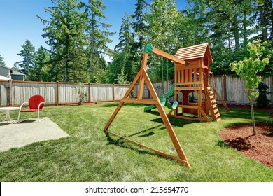 Fenced Backyard With Wooden Playground For Kids