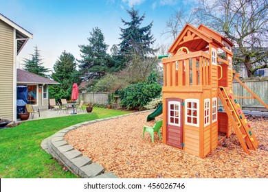 Fenced Backyard With Wooden Playground For Kids