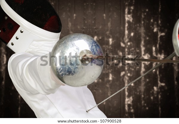 fencer athlete with\
sword and mask in action