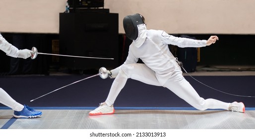 Fencer  with fencing sword. Fencers duel concept