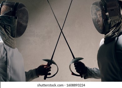 Fencer woman with fencing sword. Fencers duel concept. - Powered by Shutterstock