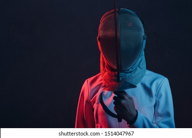 Fencer woman in mask profile portrait with fencing sword, rapier, epee.