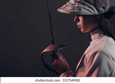 Fencer woman profile portrait with fencing sword. - Powered by Shutterstock