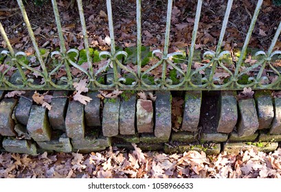 Fences: Loose Clinker Base Under An Old Wrought Iron Fence