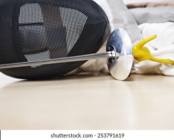 Fencing Mask And Rapier On Floor.