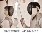 Fencing, sport and start fight with sword in training, exercise or challenge in hall. Martial arts, crossed and fencers or people with mask and costume for fitness, competition or target in swordplay