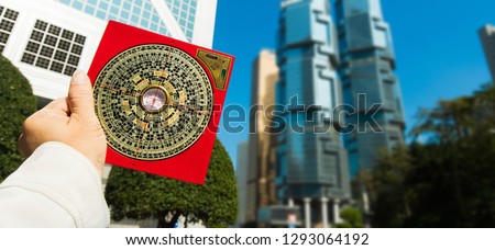 Feng Shui Master show FengShui Compass and turn direction to Force Energy, Many Chinese Texts on Compass translate as North South West East Luck Prosperity on Wind Water elements Flow Design Building
