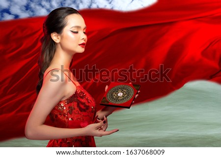 Feng Shui Master Woman show FengShui Compass and turn direction to Energy source, Girl wear Chinese Red Traditional Costume, find force flow on Sky Wind Water elements for Luck Prosperity