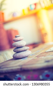 Feng Shui: Stone Cairn In The Foreground, Blurry Living Room In The Background. Balance And Relaxation.