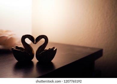 Feng Shui Swan Figurines On Bedside In Dark Light. For Love And Romance Theme.