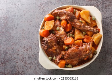 Fenkata Dish Of National Maltese Cuisine Cooked From Rabbit Meat With Vegetables And Gravy Close-up In A Saucepan On The Table. Horizontal Top View From Above
