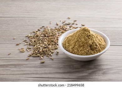 Fennel Powder And Seed On Wooden Texture Background