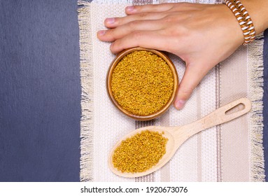 Fenugreek seeds in wooden bowl, spice, culinary ingredient, shamballa closeup