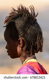 FERLO DESERT, SENEGAL - APR 25, 2017: Unidentified Fulani Little Girl With Braids Looks Ahead. Fulanis (Peul) Are The Largest Tribe In West African Savannahs