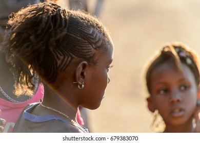 FERLO DESERT, SENEGAL - APR 25, 2017: Unidentified Fulani Little Girl With Braids Wears Earings. Fulanis (Peul) Are The Largest Tribe In West African Savannahs