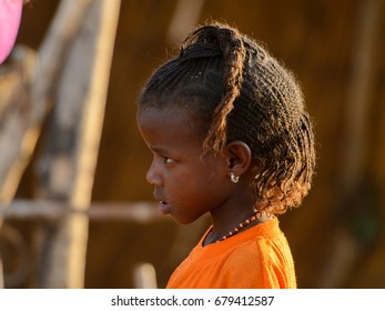 FERLO DESERT, SENEGAL - APR 25, 2017: Unidentified Fulani Little Girl With Braids Looks Ahead. Fulanis (Peul) Are The Largest Tribe In West African Savannahs