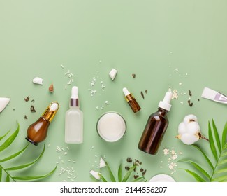 Fermented Beauty Care. Hande Made Rice Serum, Green Tea Serum, Oatmeal Cream And Coconut Water On A Green Background With Copy Space. Natural Homemade Cosmetics Based On Fermented Products. Flat Lay