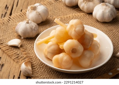 Fermented a garlic head,Pickled garlic in white plate - Shutterstock ID 2291214027