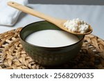 Fermented kefir drink with probiotics, kefir grains on a wooden spoon