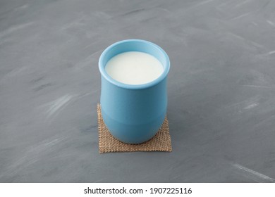 Fermented Milk Drink. Turkish Drink Ayran Or Kefir In Blue Ceramic Jug On Grey Background. Diet Drink For Weight Loss. Buttermilk From Yogurt. Selective Focus, Copy Space.