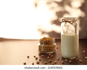 Fermented Milk Product Kefir In A Glass Jar With Pine Nuts On A Beige Background