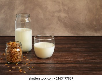 Fermented Milk Product Kefir In A Glass Jar With Granola On A Beige Background