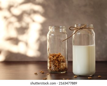 Fermented Milk Product Kefir In A Glass Jar With Granola On A Beige Background