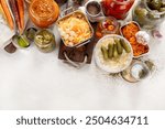 Fermented products on a wooden background. Pickled vegetables in jars. Top view, copy space