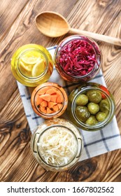 Fermented vegetables and fruits. Sauerkraut, red cabbage, cucumbers, carrots and salted lemons on a light background.Top view.