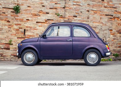 Fermo, Italy - February 11, 2016: Old Fiat Nuova 500 City Car Produced By The Italian Manufacturer Fiat Between 1957 And 1975 Stands In A Town, Side View