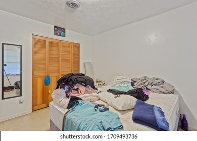 Fernandina Beach, Florida / USA - April 20 2020: Very Messy Bedroom With Lots Of Clothes Thrown Around The Room