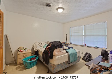 Fernandina Beach, Florida / USA - April 20 2020: Very Messy Bedroom With Lots Of Clothes Thrown Around The Room