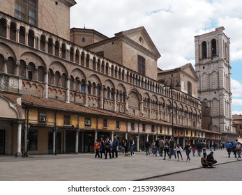Ferrara, Italy - April 25, 2022. Along the side of the cathedral is the Loggia dei Merciai, created to house the merchants' shops. At the bottom there is the bell tower of the cathedral.