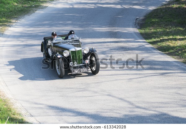 FERRARA / ITALY - MARCH 25, 2017: Classic \
vintage car: a MG TA runs in a country road during a meeting of\
historic cars. This model was built in\
1938