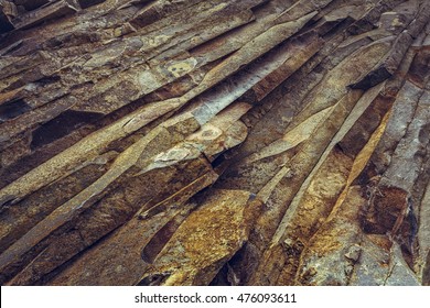 Ferric Basalt Rock Strata Closeup. Rusty Rock Pattern.