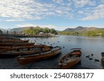 Ferries and rowing boats on shore of Derwentwater with Cat Bells at Keswick