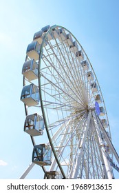 Ferris wheel against the blue sky. Modern Ferris wheel.