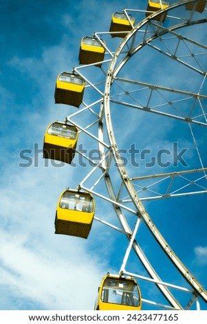 ferris wheel.
an amusement-park or fairground ride consisting of a giant vertical revolving wheel with passenger cars suspended on its outer edge.