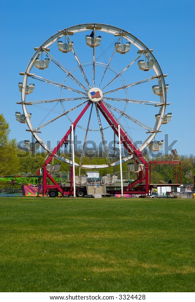 Ferris wheel at a\
carnival in the\
springtime