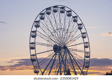 Ferris wheel - carousel, viewing wheel against the background of the setting sun - Powered by Shutterstock