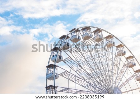 Ferris wheel close up in Carnival funfair, outdoor, evening