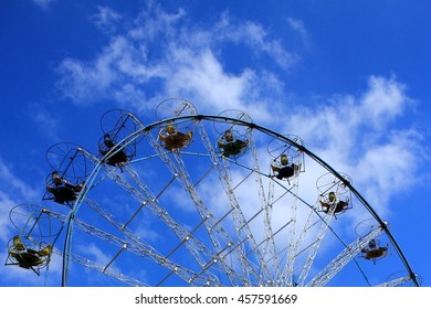 Ferris wheel with closed cabins on background of blue sky - Shutterstock ID 457591669