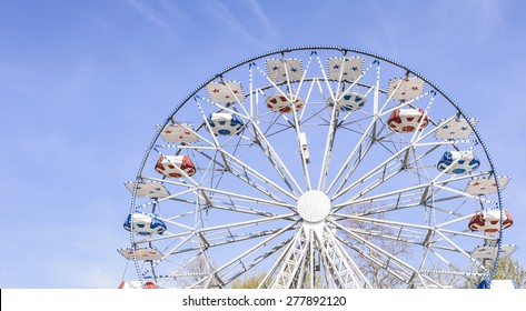 Ferris Wheel At The County Fair With The Sky In The Background