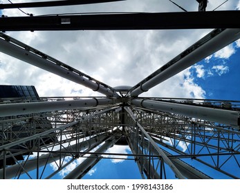 Ferris wheel - low angle view with blue sky and white clouds 