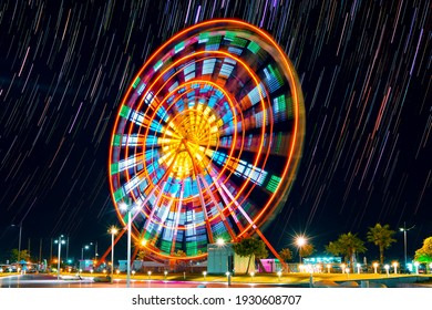Ferris wheel at night in Batumi, Georgia (long exposure with star trails in the night sky)