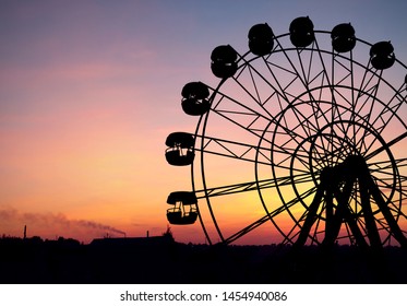 Ferris wheel at orange sunset