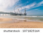 The Ferris Wheel & The Pier at Scheveningen in Netherlands, Sunny spring day at the beach