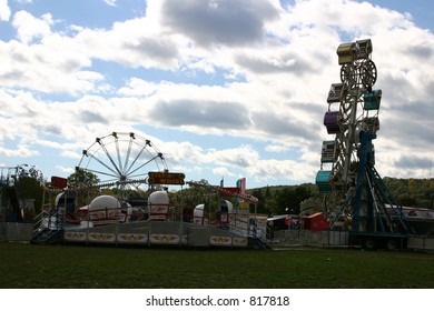 Ferris Wheel And Tilt A Whirl At A City Carnival.